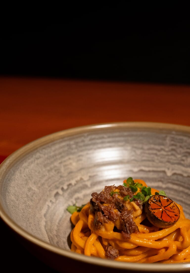 Goxo crab uni and anchovy udon beautifully plated in artisan bowl